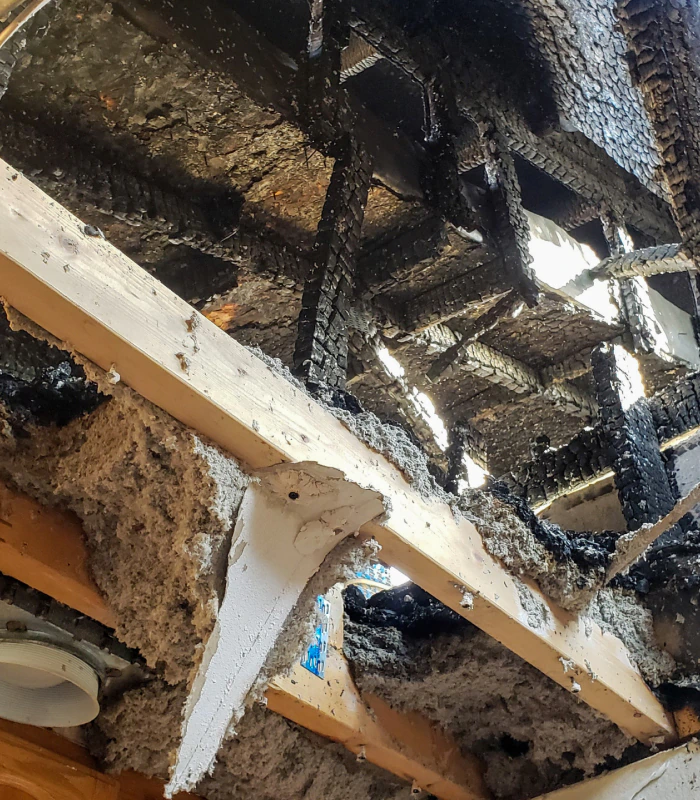 fire damage on the ceiling of house charred wood frames